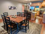 Dining table with seating for 8 and breakfast bar with 3 stools.
